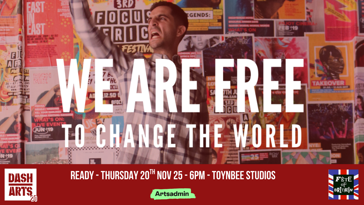 A man standing in front of a wall of art and protest posters exclaiming 'We are free to change the world'